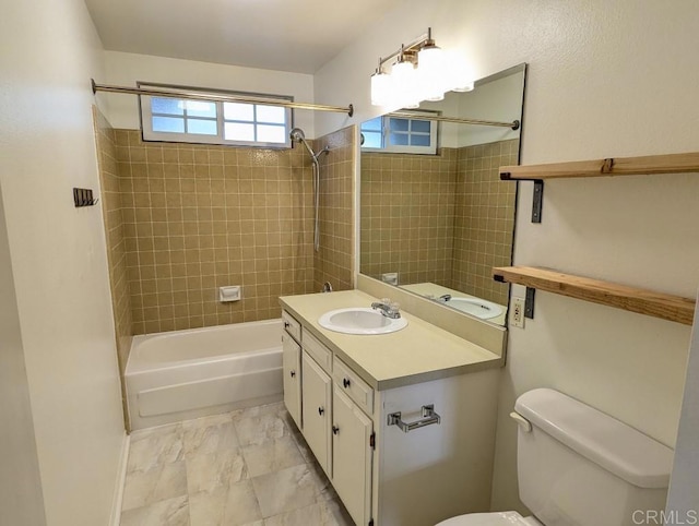 full bathroom with vanity, toilet, and tiled shower / bath