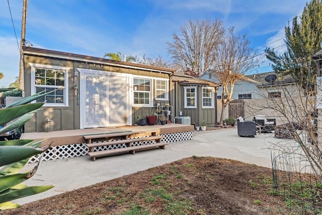 back of property featuring central AC, a patio area, and a deck