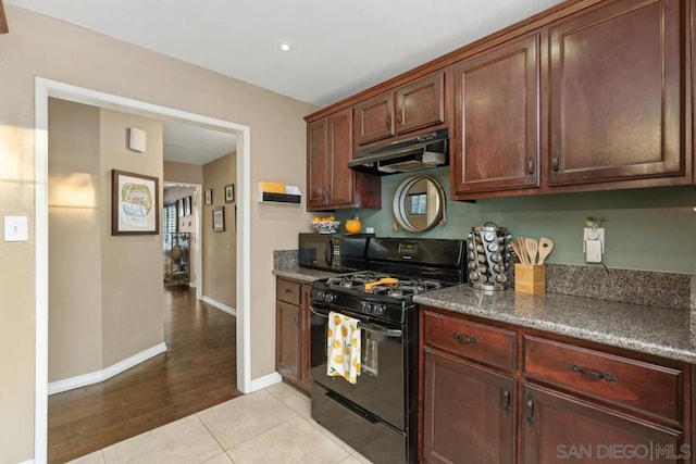 kitchen featuring light tile patterned floors and black appliances