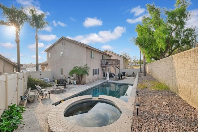 view of swimming pool featuring an in ground hot tub, a patio, and a fire pit