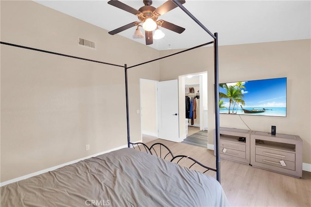 bedroom featuring vaulted ceiling, ceiling fan, and light wood-type flooring