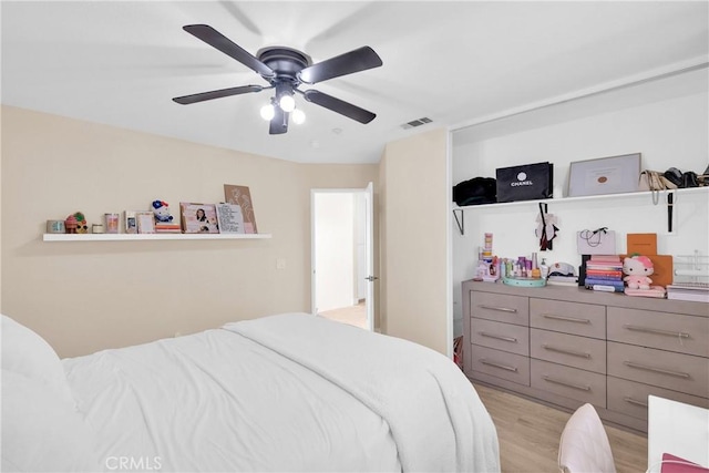 bedroom with ceiling fan and light hardwood / wood-style floors