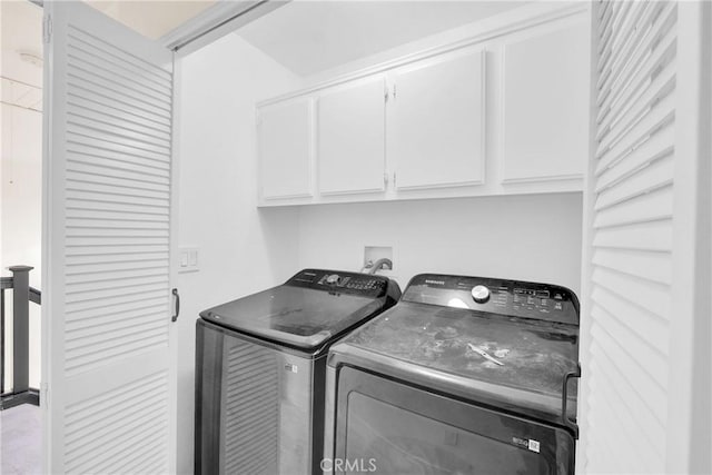 laundry area with cabinets and washing machine and dryer