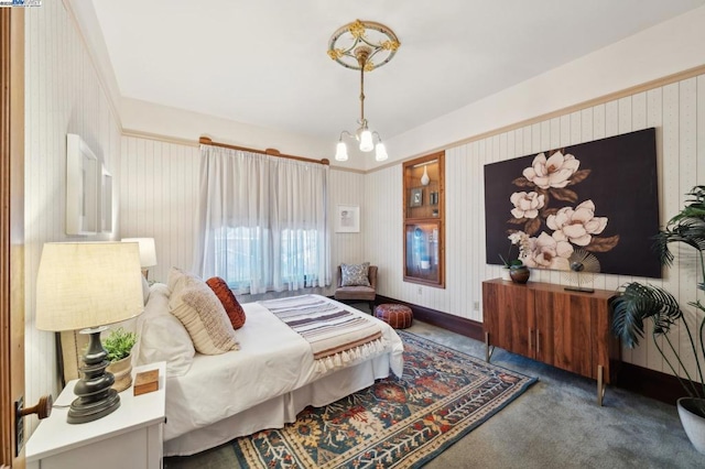 carpeted bedroom with an inviting chandelier