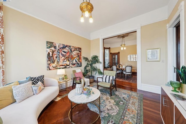 living room featuring an inviting chandelier and dark hardwood / wood-style floors