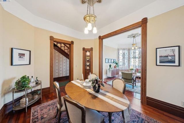 dining area featuring dark hardwood / wood-style floors and a chandelier