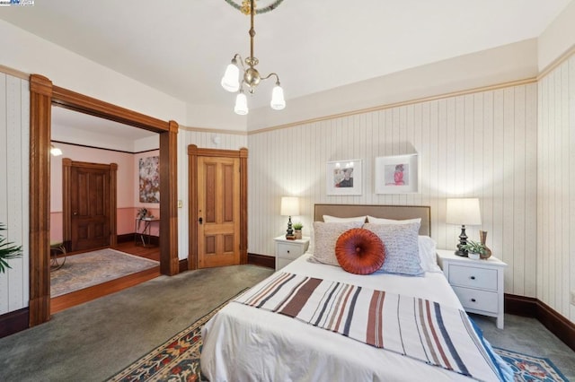 carpeted bedroom featuring a notable chandelier