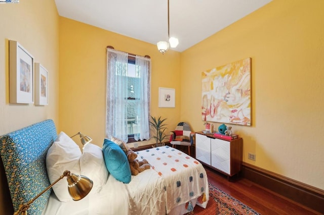 bedroom with dark hardwood / wood-style floors