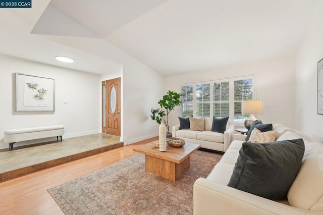 living room featuring vaulted ceiling and hardwood / wood-style floors