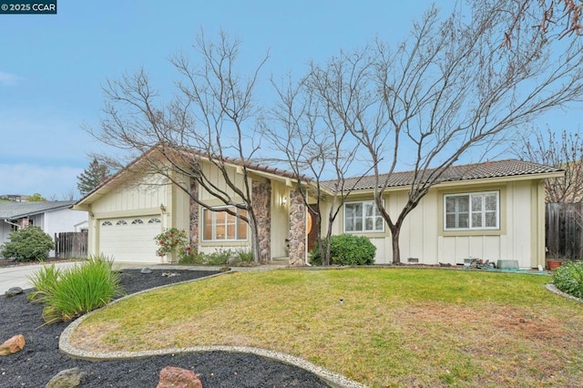 ranch-style home with a garage and a front lawn