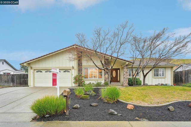 ranch-style home featuring a garage and a front yard