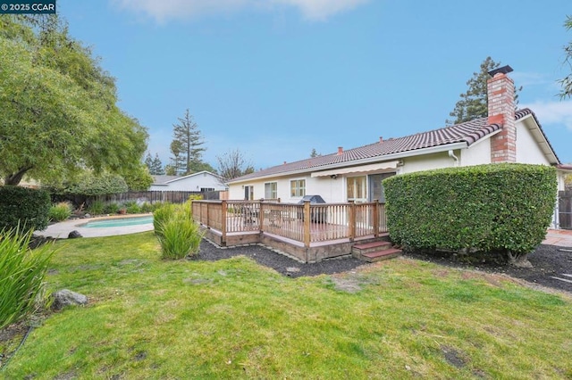 view of yard with a swimming pool side deck