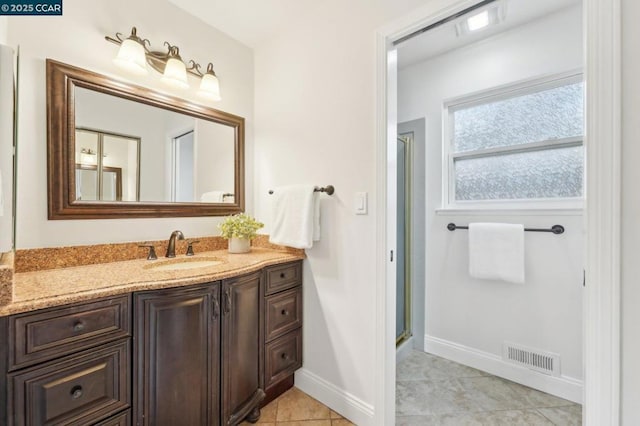 bathroom featuring tile patterned flooring, vanity, and an enclosed shower