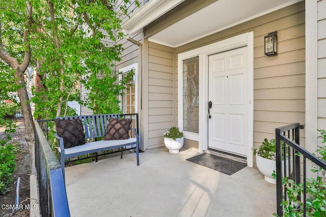 view of exterior entry featuring a porch