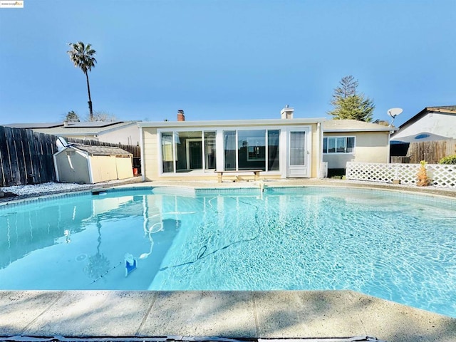 view of swimming pool featuring a shed