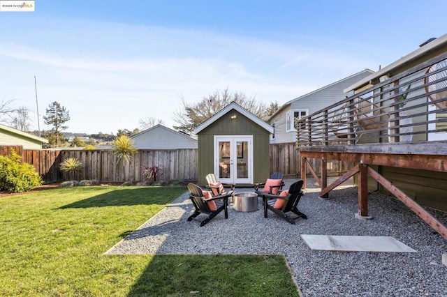 view of yard featuring an outdoor structure and a fire pit