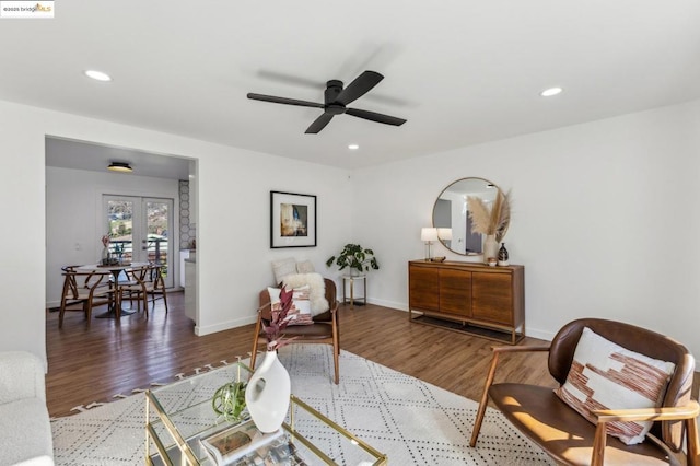 sitting room featuring hardwood / wood-style floors, ceiling fan, and french doors