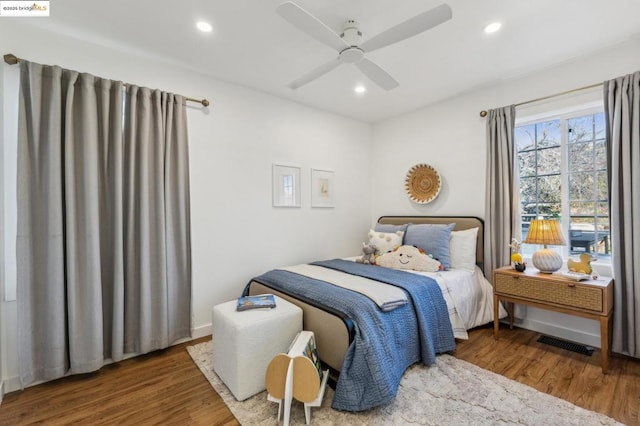 bedroom featuring dark hardwood / wood-style flooring and ceiling fan