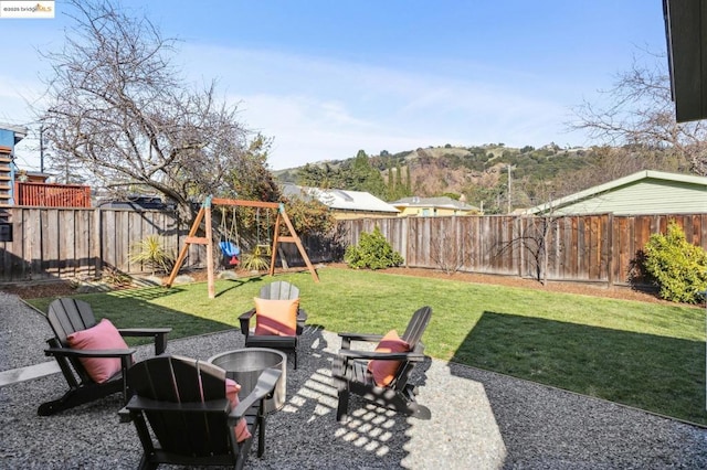 view of yard featuring an outdoor fire pit and a playground