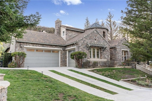 view of front of property with a front lawn, concrete driveway, a chimney, and an attached garage