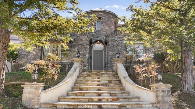 view of exterior entry featuring stone siding