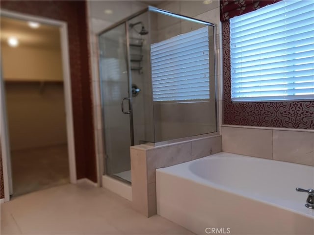 bathroom featuring separate shower and tub