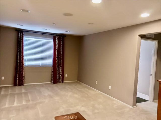 unfurnished room featuring light carpet