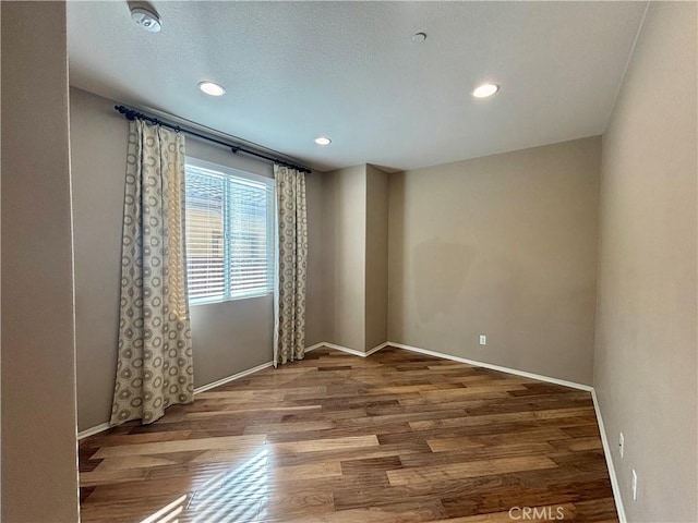 empty room with wood-type flooring