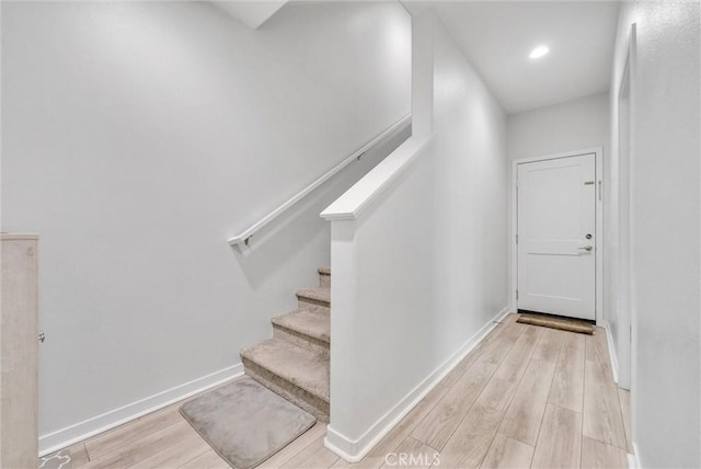 stairway featuring wood-type flooring