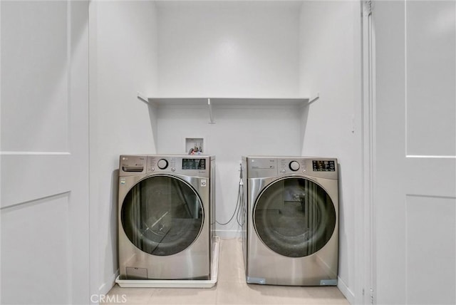 laundry room with washing machine and clothes dryer