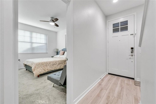 interior space with ceiling fan and light wood-type flooring