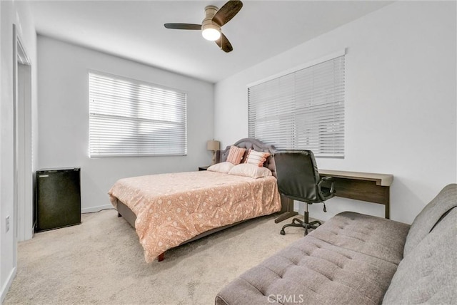 bedroom featuring ceiling fan and light carpet