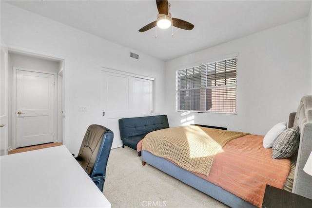 bedroom with carpet floors, a closet, and ceiling fan