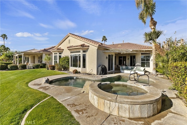 back of house with a swimming pool with hot tub, a patio, and a lawn