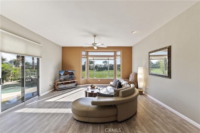 living room featuring light hardwood / wood-style flooring and ceiling fan