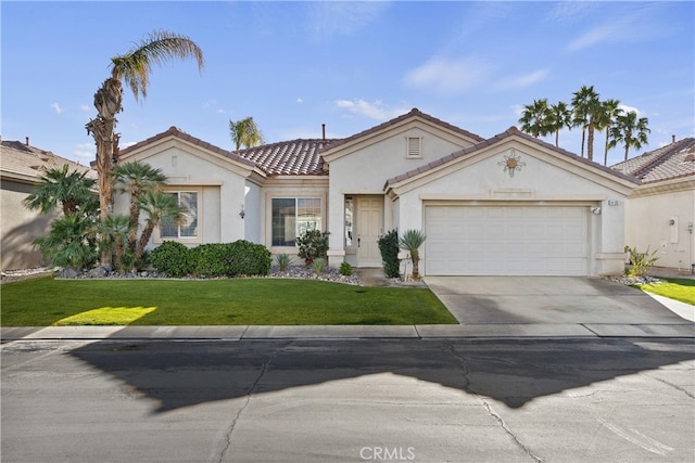 mediterranean / spanish-style home with a garage and a front lawn