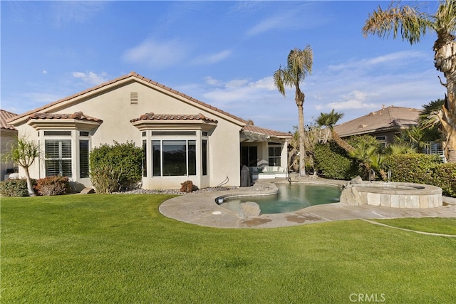 rear view of property with a yard and a patio area