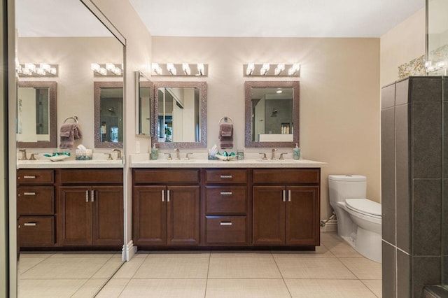 bathroom featuring vanity, tile patterned floors, and toilet