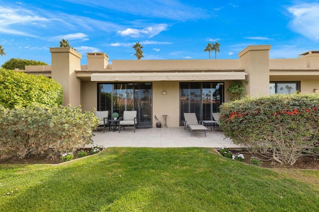 back of house with a yard and a patio area