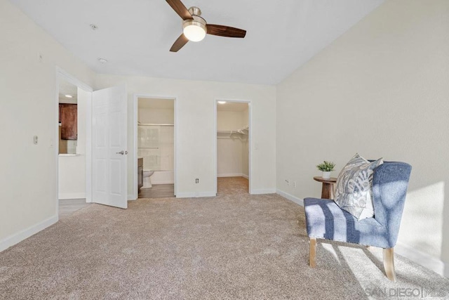 living area featuring vaulted ceiling, light colored carpet, and ceiling fan