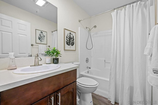 full bathroom featuring shower / tub combo with curtain, vanity, toilet, and hardwood / wood-style floors