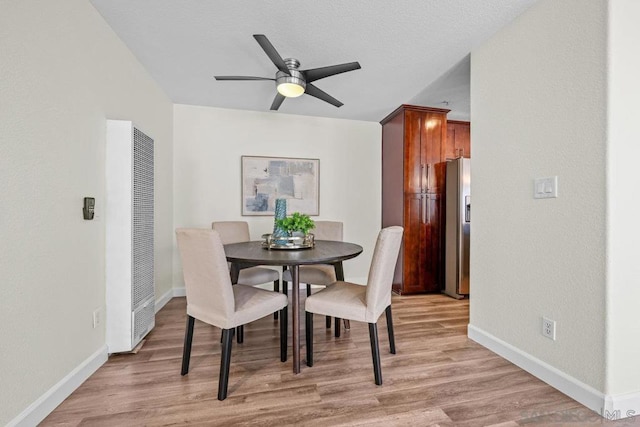 dining room with ceiling fan and light hardwood / wood-style floors