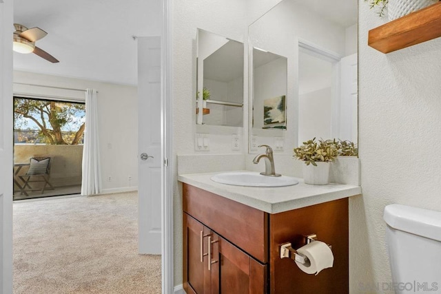 bathroom featuring ceiling fan, vanity, and toilet