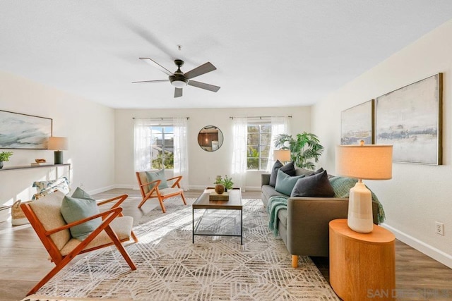 living room featuring ceiling fan and light hardwood / wood-style flooring