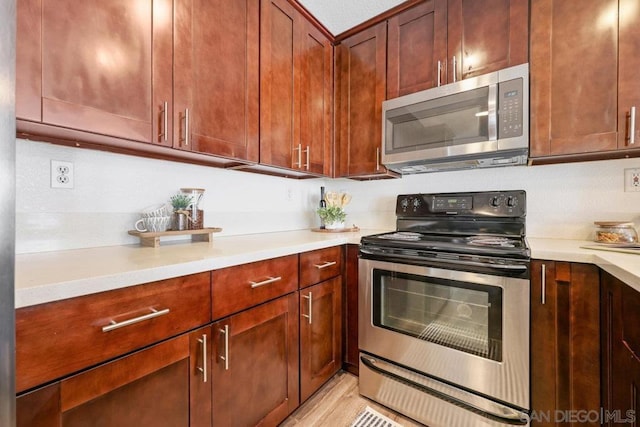 kitchen featuring appliances with stainless steel finishes and light wood-type flooring