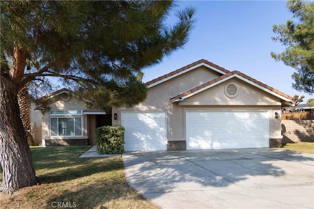 view of front of home with a garage and a front lawn