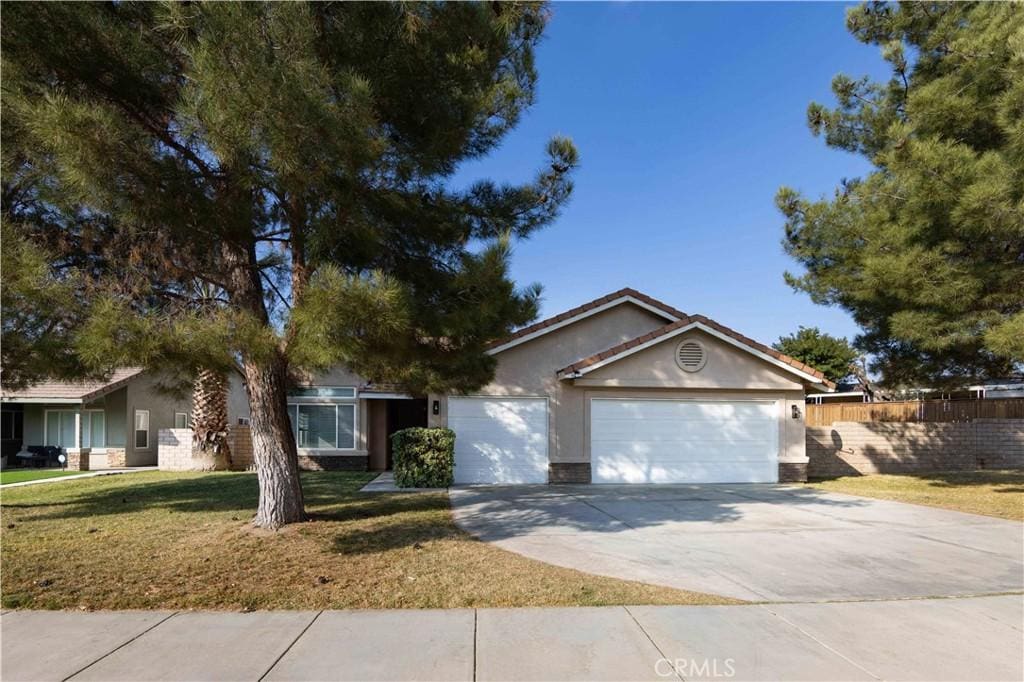 single story home with a garage and a front yard