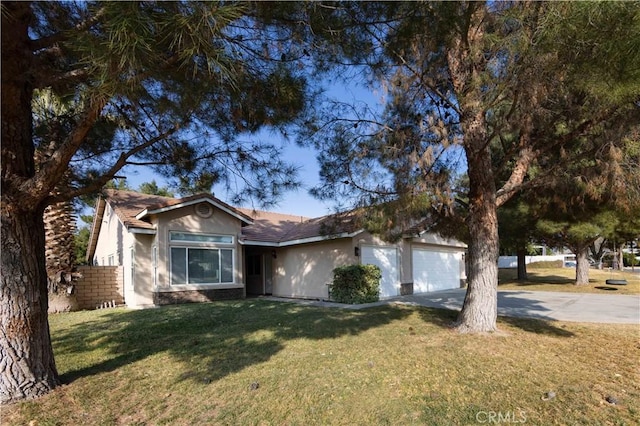 single story home featuring a garage and a front lawn