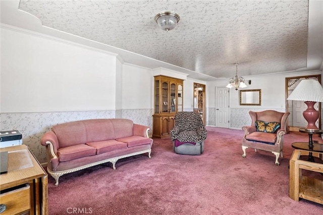 living room with a notable chandelier, carpet floors, ornamental molding, and a textured ceiling