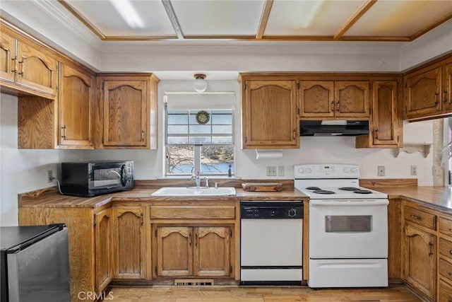 kitchen featuring white appliances and sink